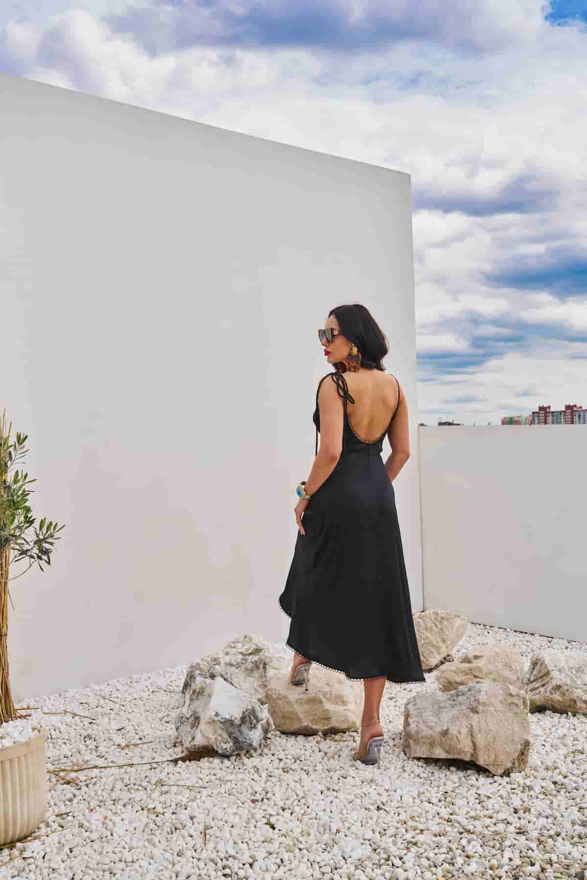 Black combination dress with draped chest and open back