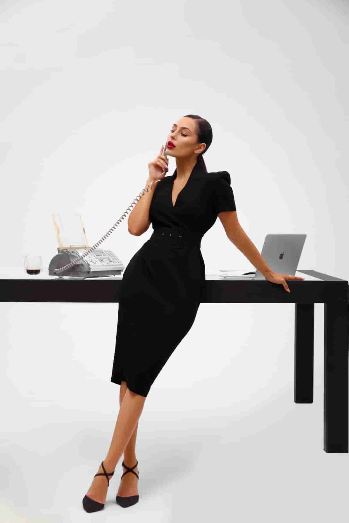 Black sheath dress with a wide belt