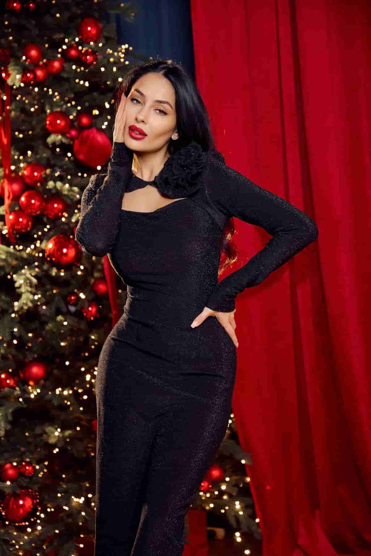 Black dress with a scoop neckline and a flower