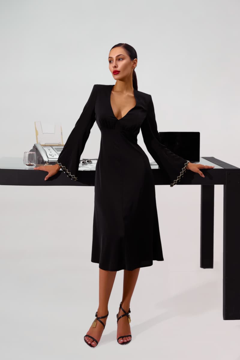 Black silhouette dress with a skirt - gode and trim with metal inserts on the sleeves