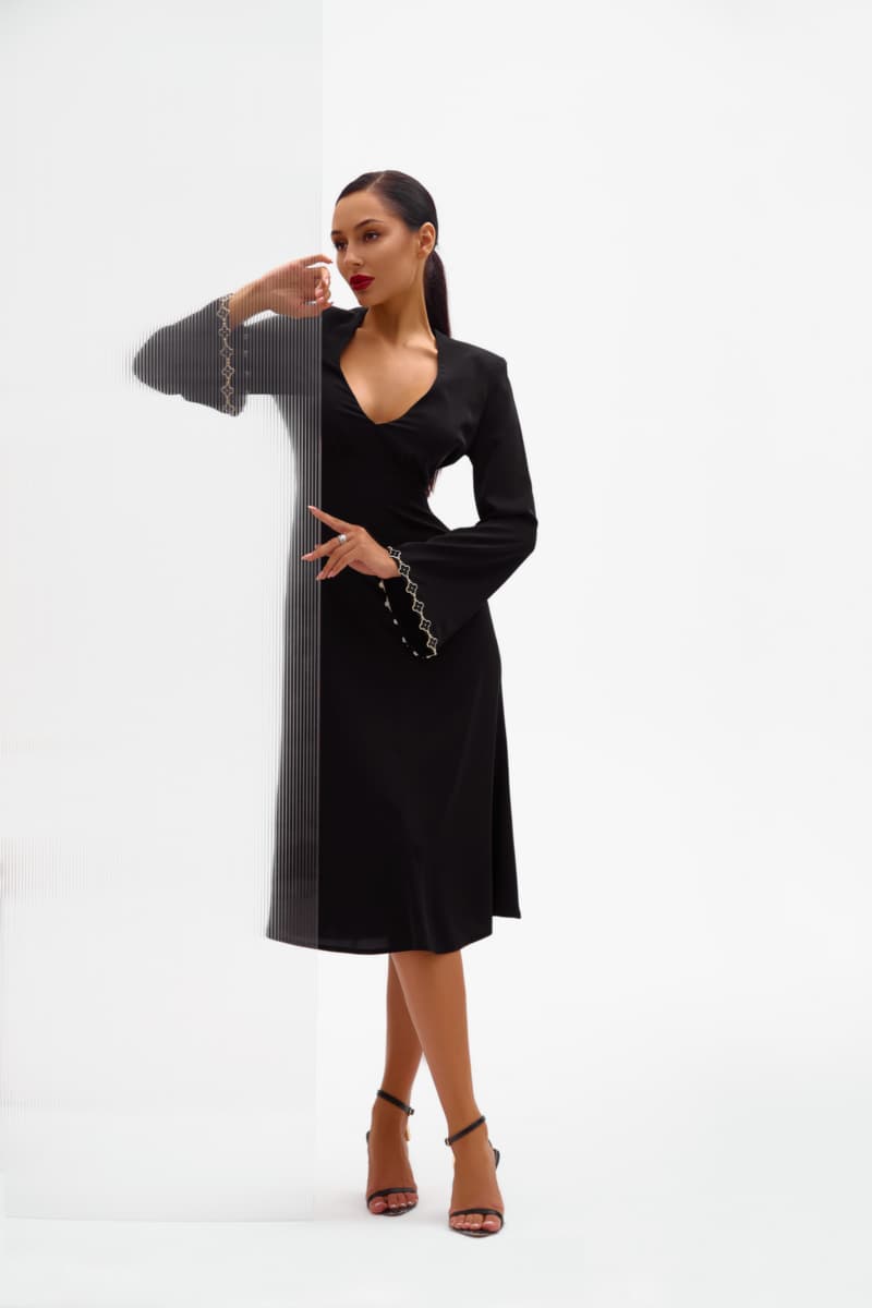 Black silhouette dress with a skirt - gode and trim with metal inserts on the sleeves