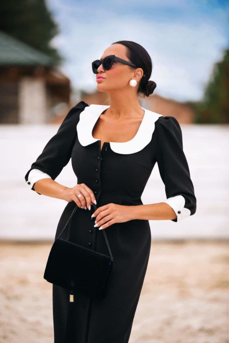 Black sheath dress with white collar and cuffs