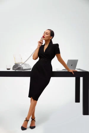 Black sheath dress with a wide belt